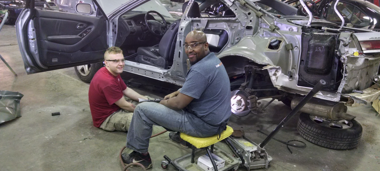 Newgate auto body students repairing a car in the shop